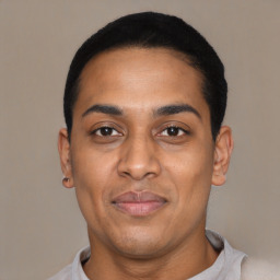 Joyful latino young-adult male with short  black hair and brown eyes