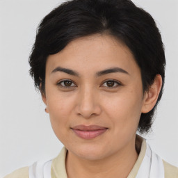 Joyful latino young-adult female with medium  brown hair and brown eyes