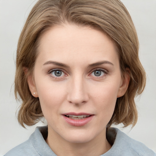 Joyful white young-adult female with medium  brown hair and blue eyes