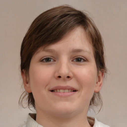 Joyful white child female with medium  brown hair and blue eyes