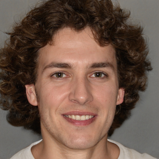 Joyful white adult male with medium  brown hair and brown eyes