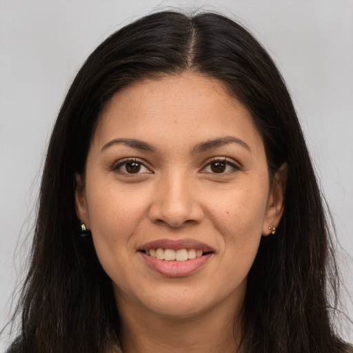 Joyful white young-adult female with long  brown hair and brown eyes