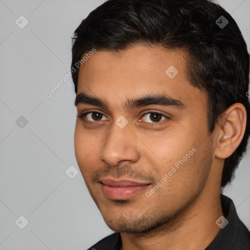 Joyful latino young-adult male with short  black hair and brown eyes