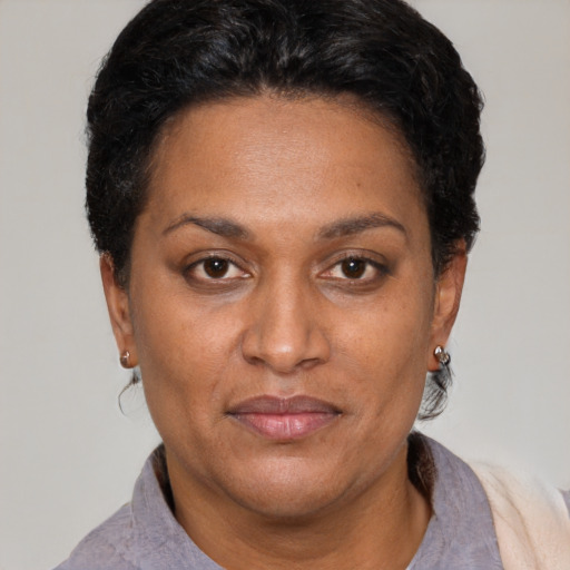 Joyful latino adult female with short  black hair and brown eyes
