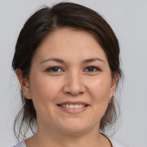 Joyful white adult female with medium  brown hair and brown eyes