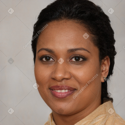 Joyful black young-adult female with long  brown hair and brown eyes