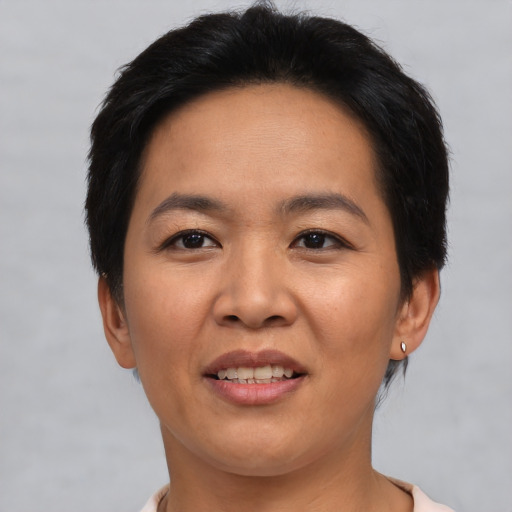 Joyful asian adult female with short  black hair and brown eyes
