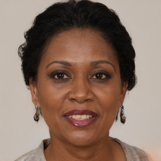 Joyful black adult female with medium  brown hair and brown eyes