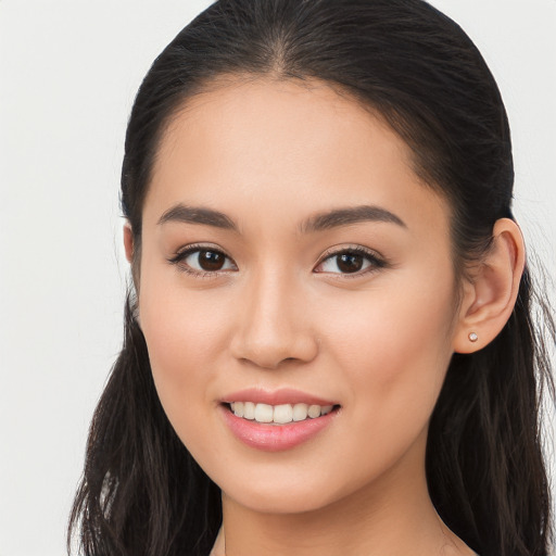 Joyful white young-adult female with long  brown hair and brown eyes