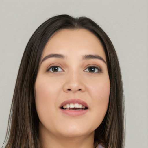 Joyful white young-adult female with long  black hair and brown eyes