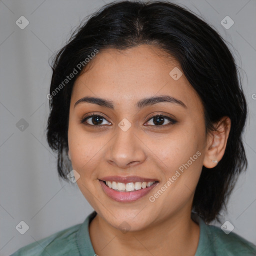 Joyful latino young-adult female with medium  brown hair and brown eyes