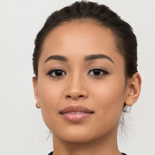 Joyful latino young-adult female with long  brown hair and brown eyes