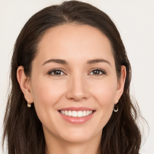 Joyful white young-adult female with long  brown hair and brown eyes