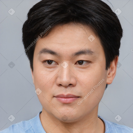 Joyful asian young-adult male with short  brown hair and brown eyes