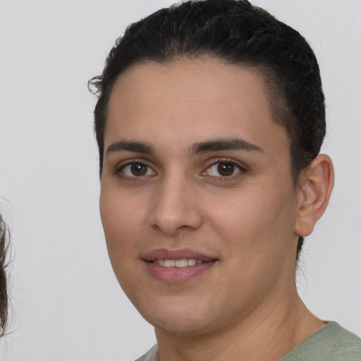 Joyful white young-adult female with short  black hair and brown eyes