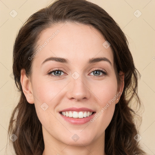 Joyful white young-adult female with long  brown hair and green eyes