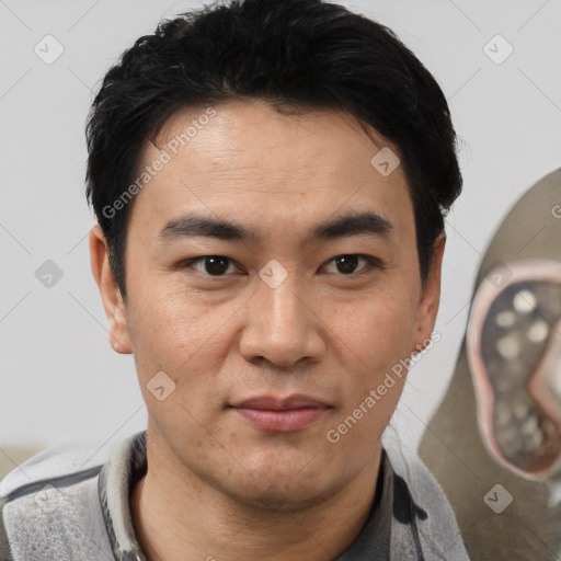 Joyful white adult male with short  black hair and brown eyes
