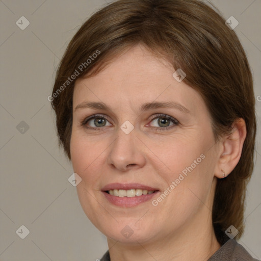 Joyful white adult female with medium  brown hair and green eyes