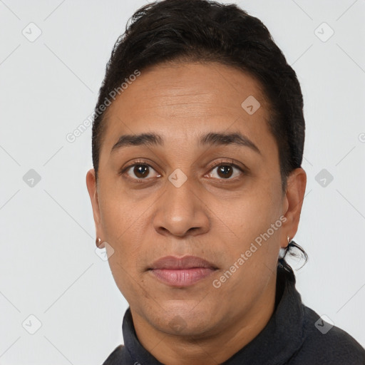 Joyful latino young-adult female with short  black hair and brown eyes