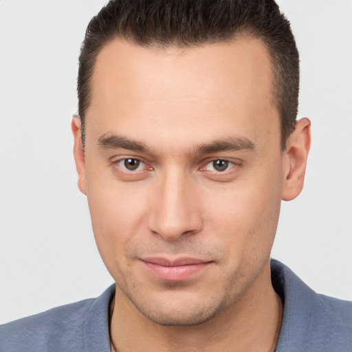 Joyful white young-adult male with short  brown hair and brown eyes