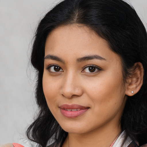 Joyful latino young-adult female with medium  black hair and brown eyes