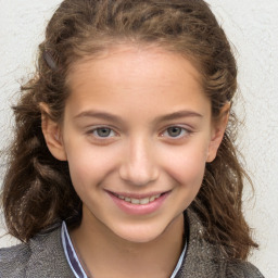 Joyful white child female with long  brown hair and brown eyes