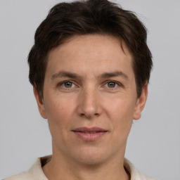 Joyful white adult male with short  brown hair and grey eyes