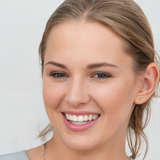 Joyful white young-adult female with long  brown hair and blue eyes