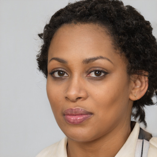 Joyful black young-adult female with medium  brown hair and brown eyes