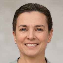 Joyful white adult female with short  brown hair and brown eyes