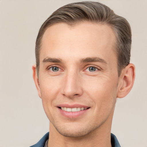 Joyful white young-adult male with short  brown hair and grey eyes