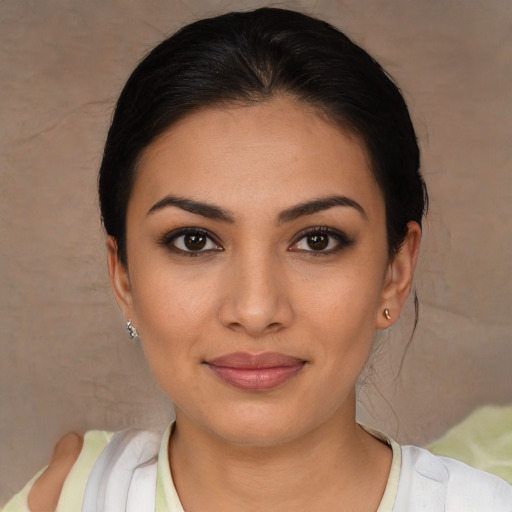 Joyful latino young-adult female with medium  brown hair and brown eyes