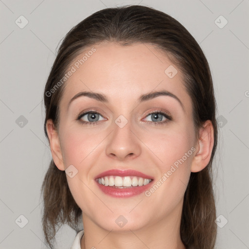 Joyful white young-adult female with medium  brown hair and grey eyes