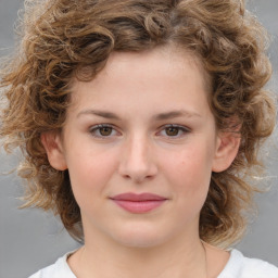 Joyful white child female with medium  brown hair and brown eyes