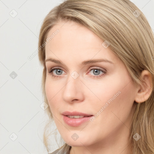 Joyful white young-adult female with long  brown hair and blue eyes