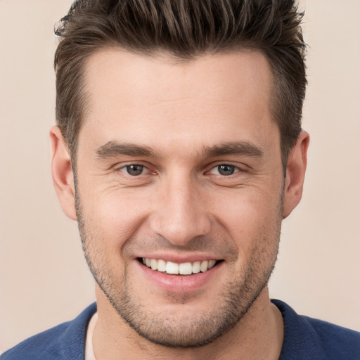 Joyful white young-adult male with short  brown hair and brown eyes