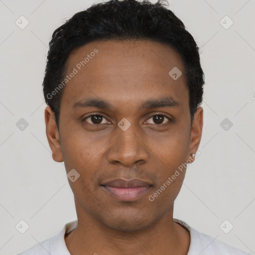 Joyful black young-adult male with short  black hair and brown eyes