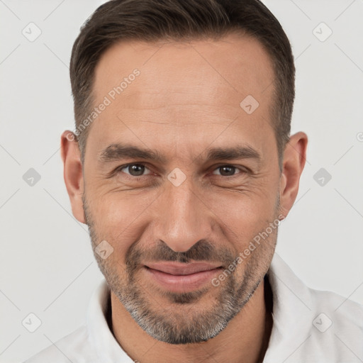 Joyful white adult male with short  brown hair and brown eyes