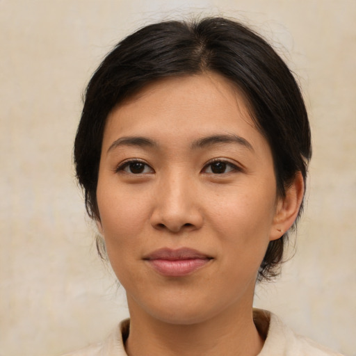 Joyful asian young-adult female with medium  brown hair and brown eyes