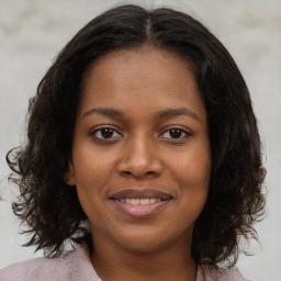 Joyful black young-adult female with medium  brown hair and brown eyes