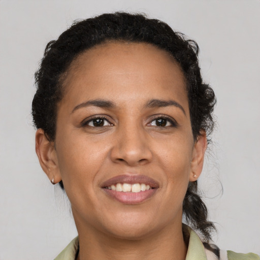 Joyful latino adult female with medium  brown hair and brown eyes