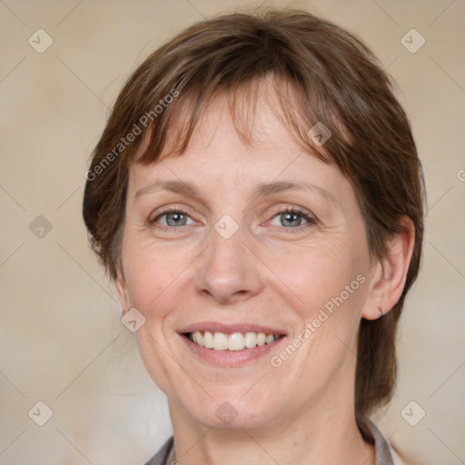 Joyful white adult female with medium  brown hair and grey eyes