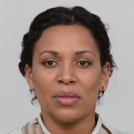 Joyful black adult female with short  brown hair and brown eyes