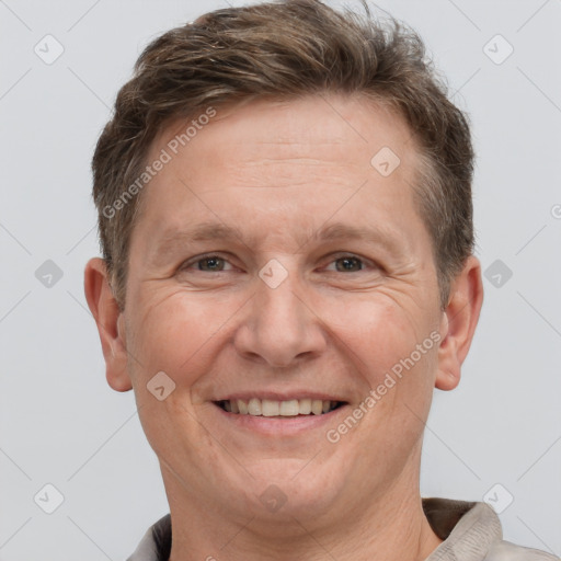 Joyful white adult male with short  brown hair and grey eyes