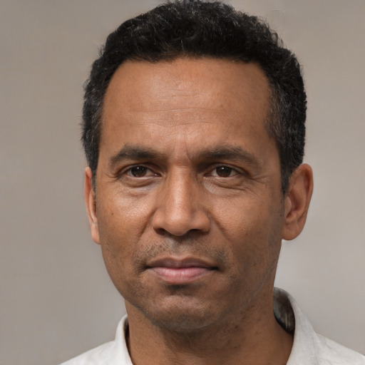 Neutral latino adult male with short  black hair and brown eyes