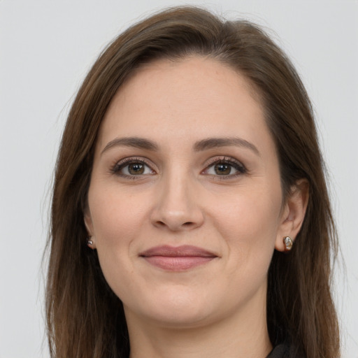 Joyful white young-adult female with long  brown hair and grey eyes