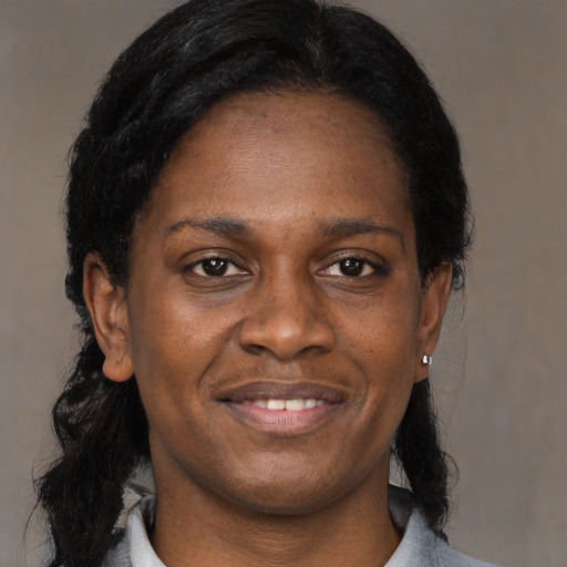 Joyful black adult female with medium  black hair and brown eyes