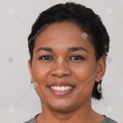 Joyful black young-adult female with short  brown hair and brown eyes