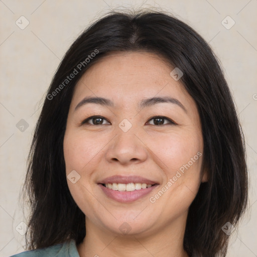 Joyful asian adult female with medium  brown hair and brown eyes