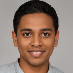 Joyful latino young-adult male with short  black hair and brown eyes